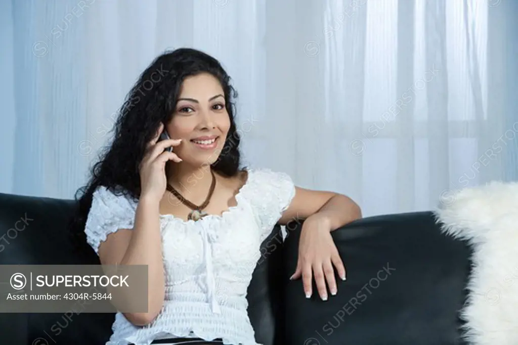 Young woman using mobile phone, portrait