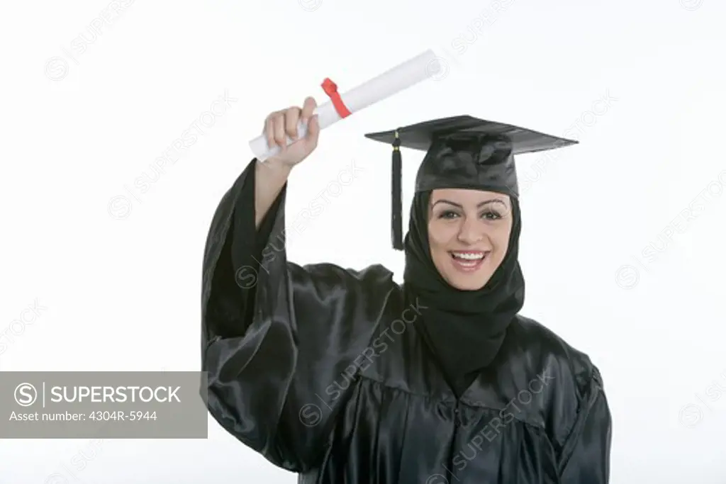 Young woman holding diploma, smiling, portrait
