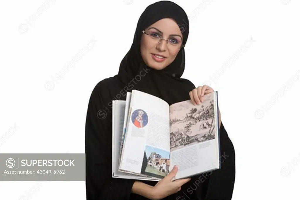Young woman showing book, portrait