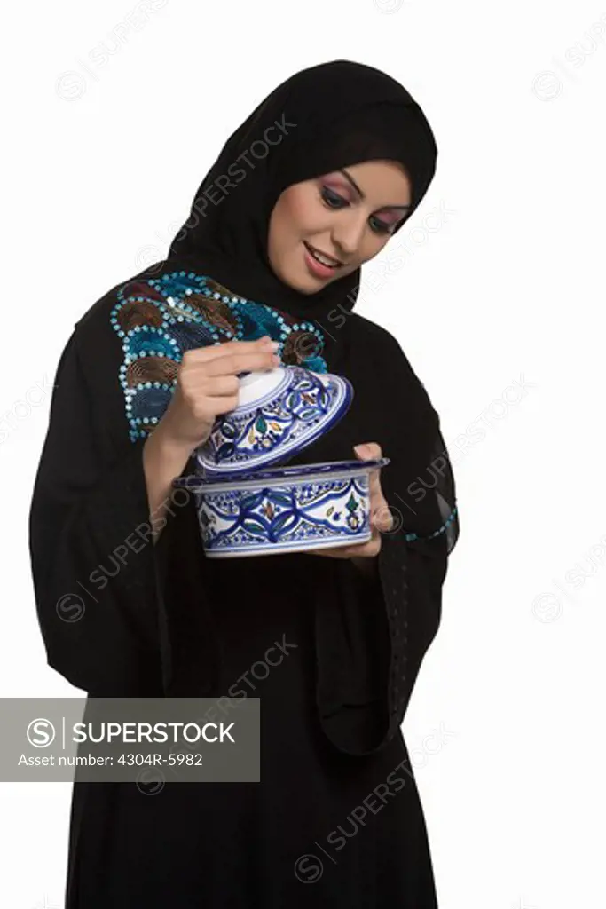 Young woman looking into bowl, smiling