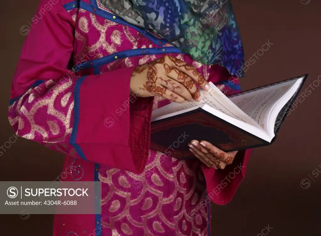 Human hand holding Koran, close-up