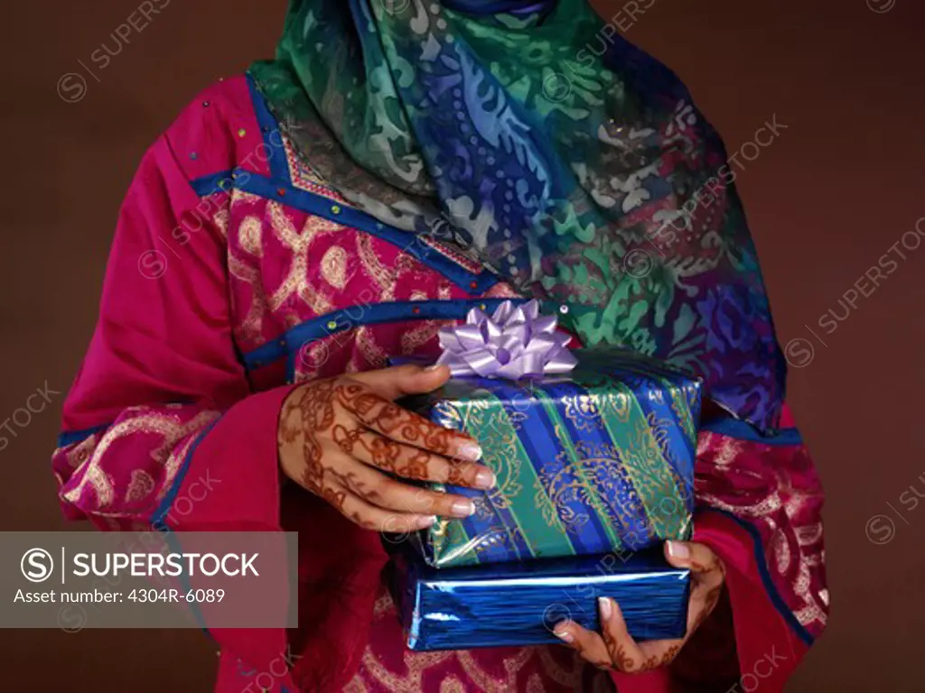 Young woman holding gift, close-up