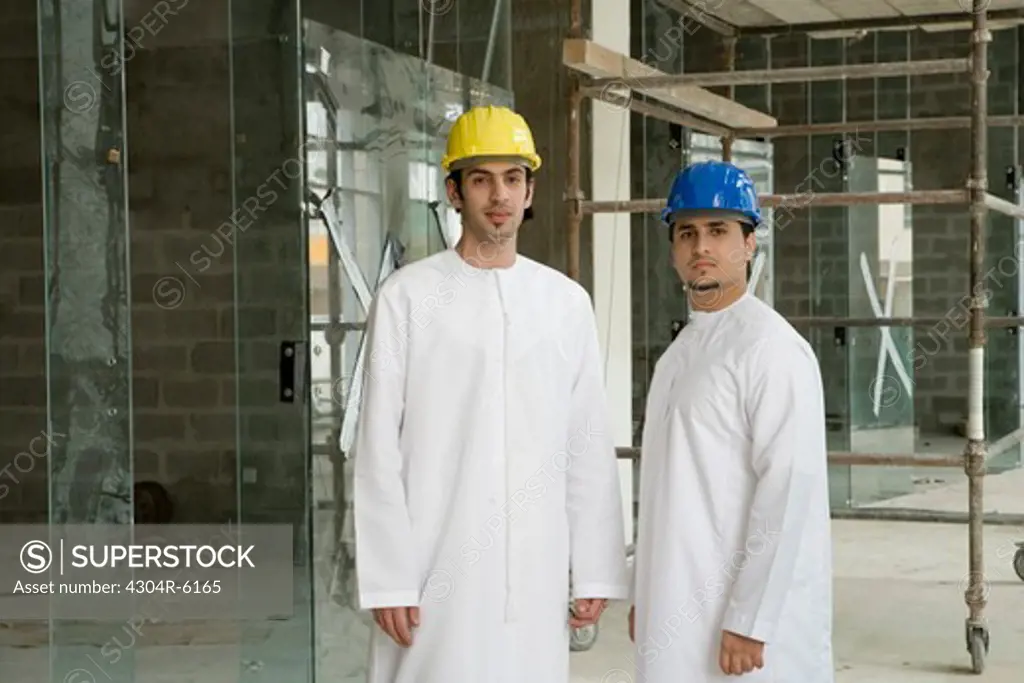 Businessmen at construction site, portrait