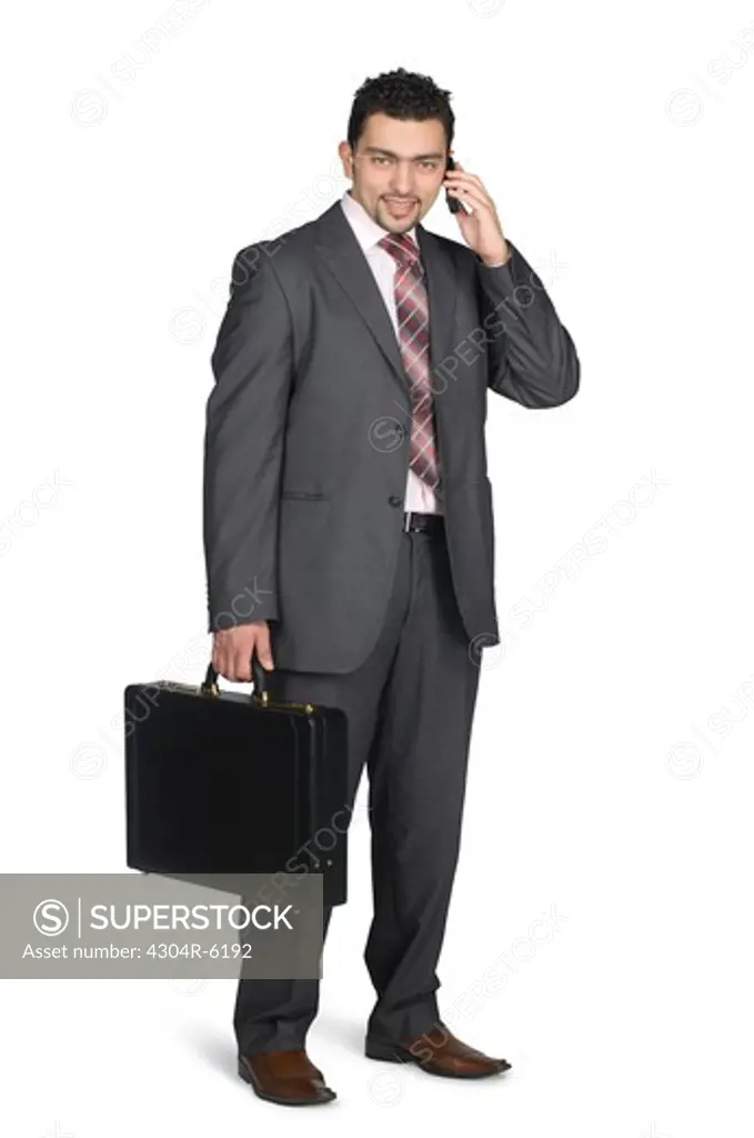 Businessman holding mobile phone and briefcase, portrait