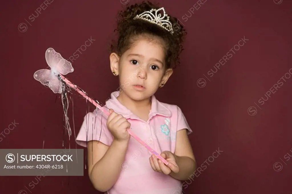 Girl holding magic wand, portrait