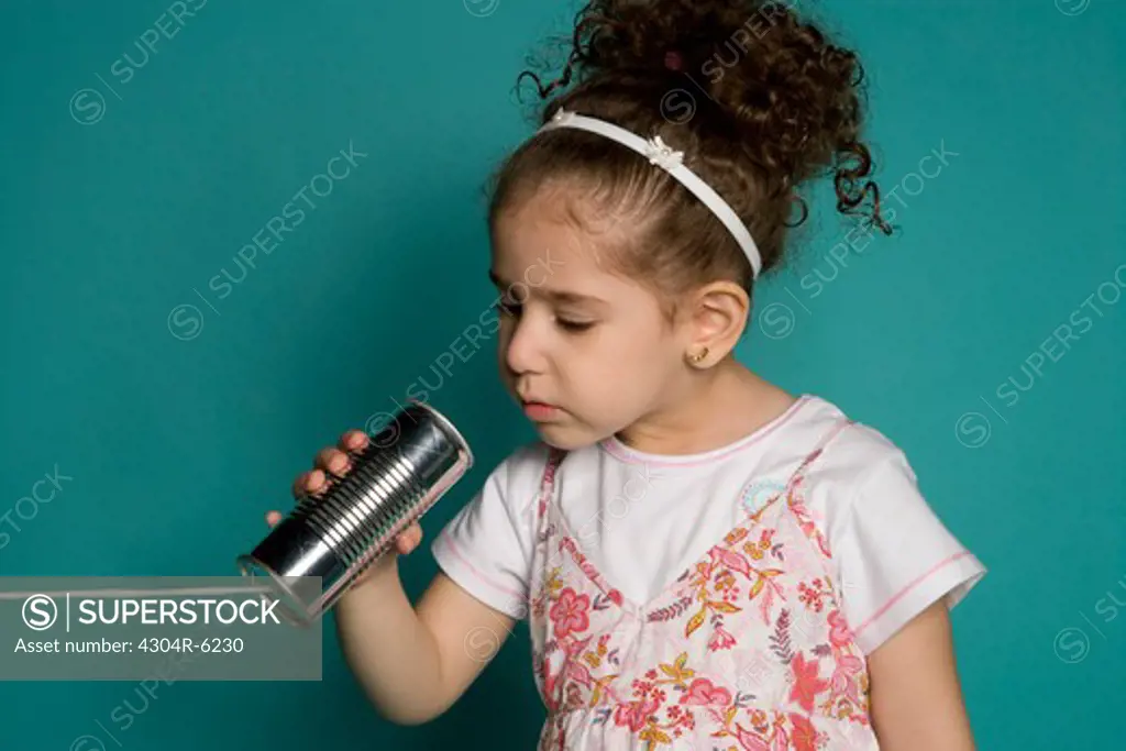 Girl holding tin can phone