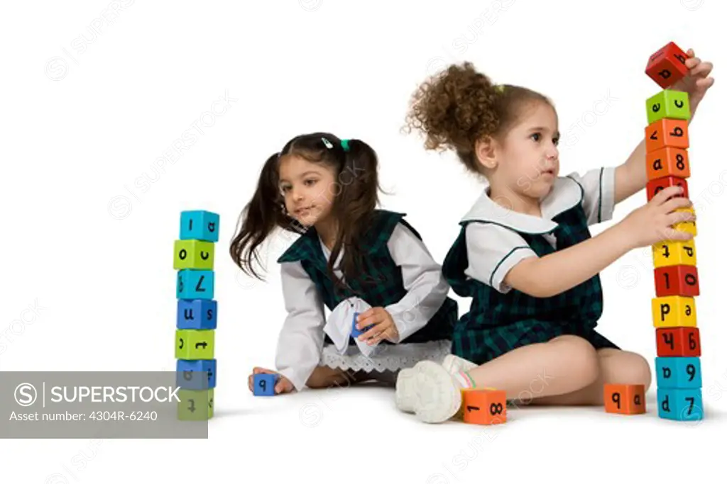Girls playing with plastic blocks