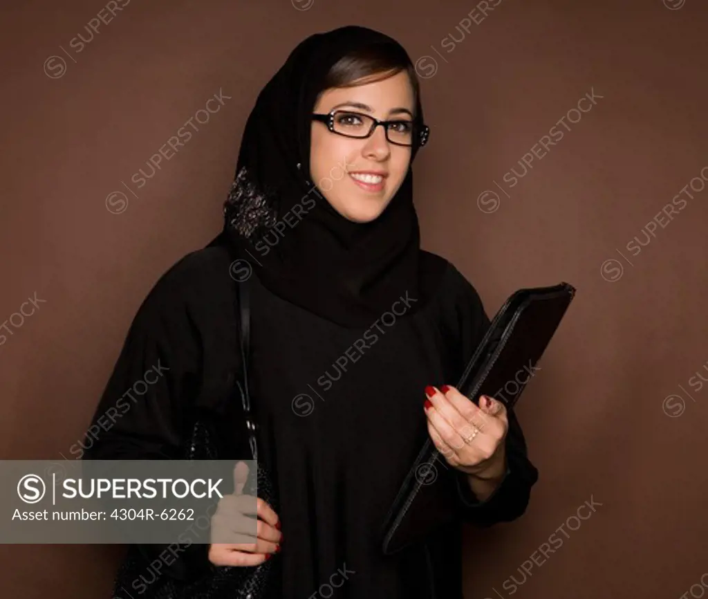 Young woman with glasses and file, portrait