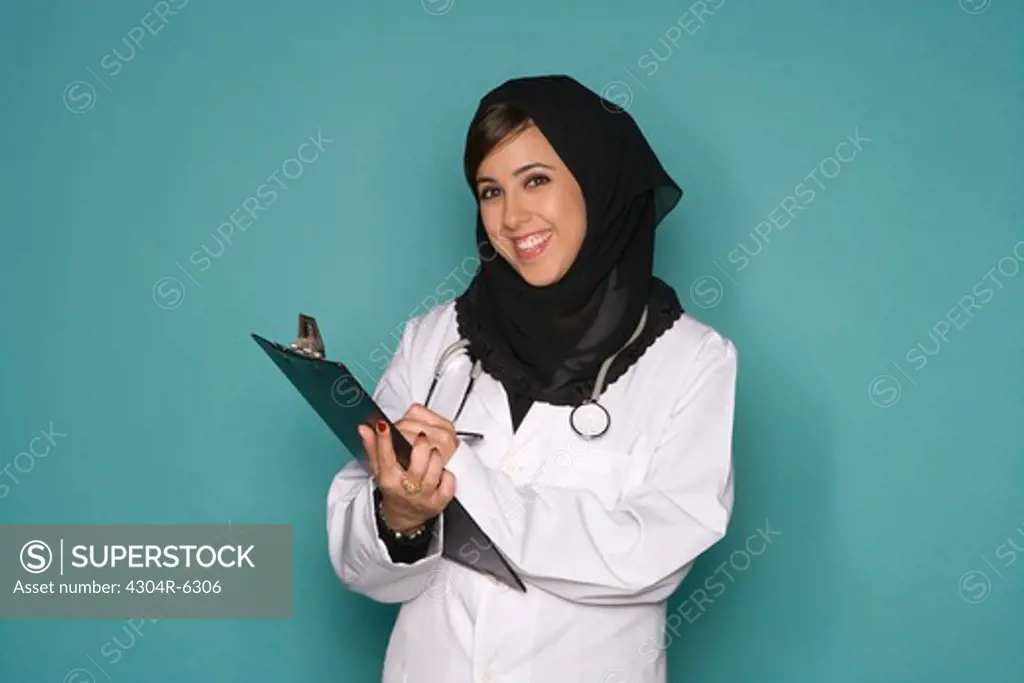 Female doctor with clipboard, portrait