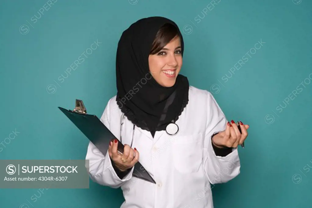 Female doctor with clipboard, portrait