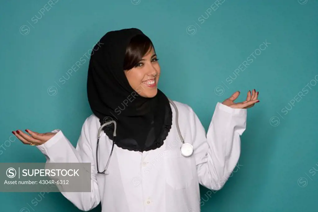 Female doctor with stethoscope gesturing, portrait