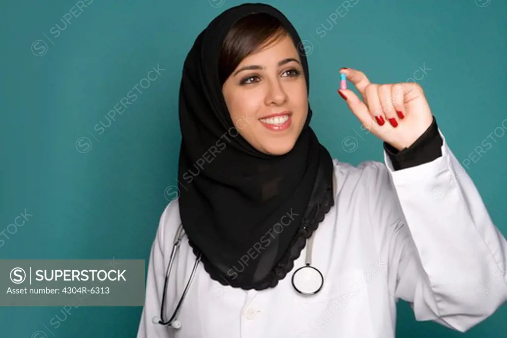 Female doctor holding capsule