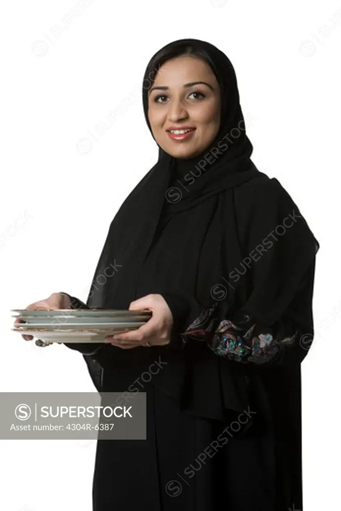 Young woman holding plates, portrait