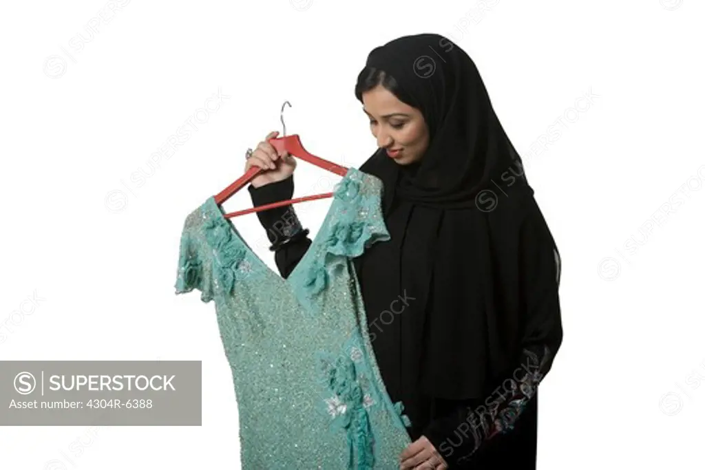 Young woman holding hanger