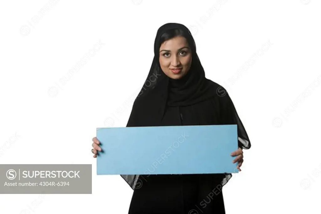 Young woman holding blank placard, portrait