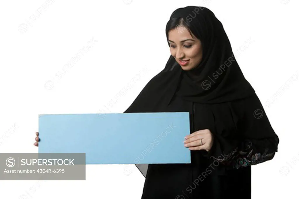 Young woman holding blank placard