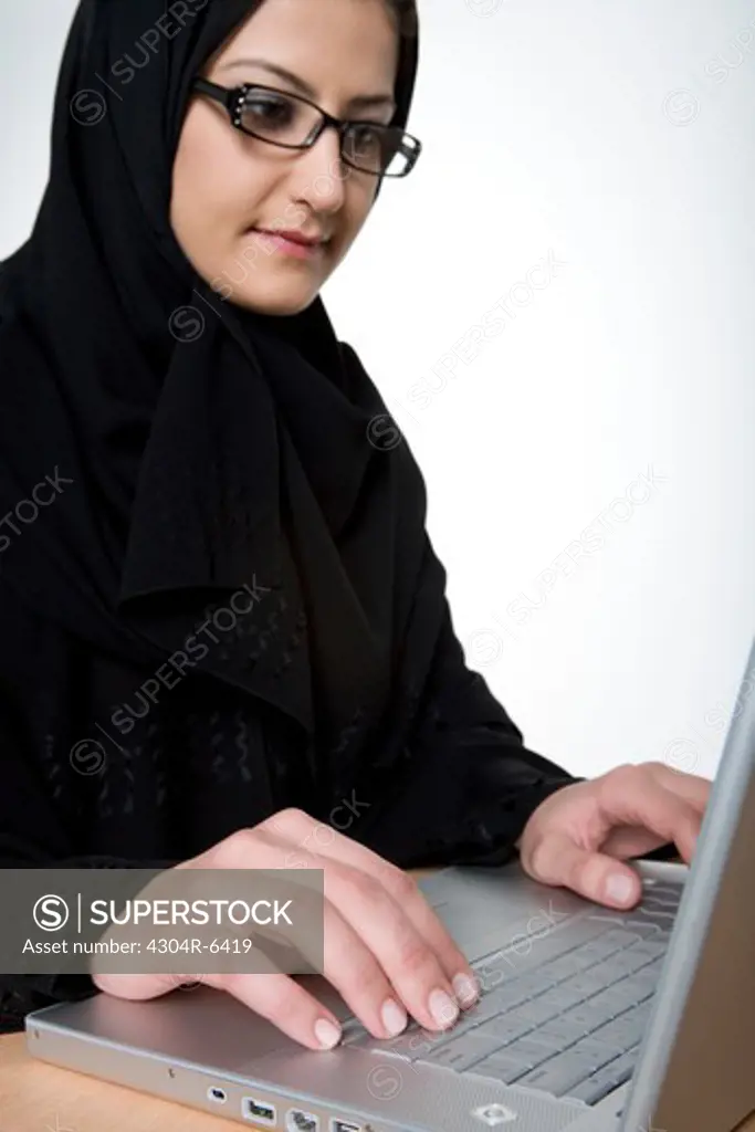 Young woman using laptop, close-up