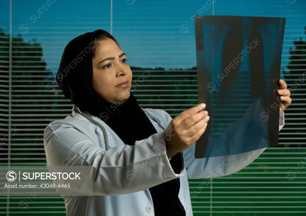 Female doctor examining X-ray