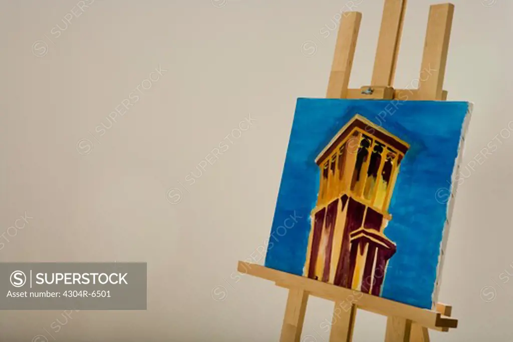 Easel with painting against wall