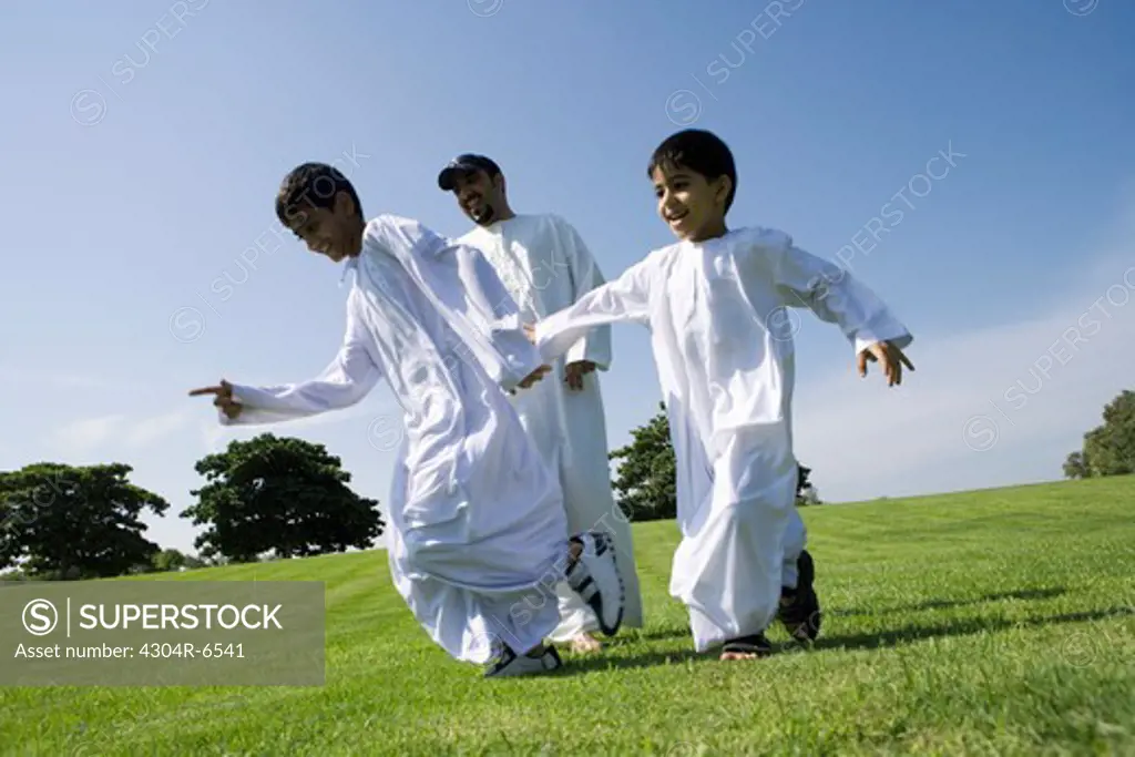 Father with children enjoying at park, smiling