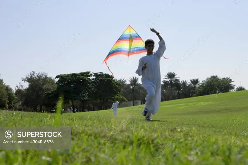 Boy holding kite in park