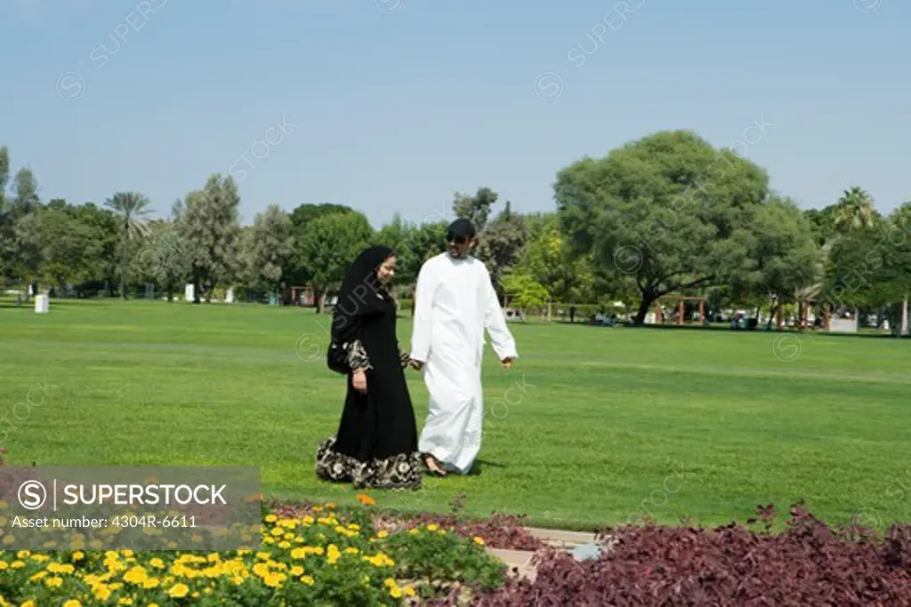 Mid adult couple walking at park
