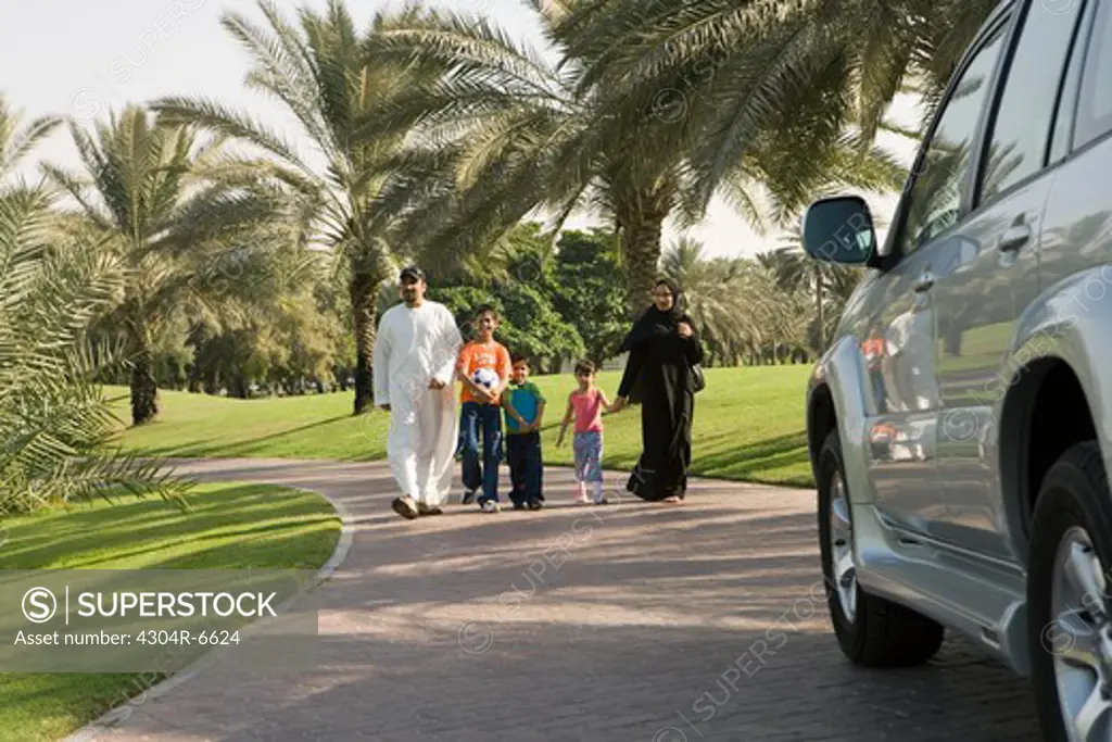 Parents with children walking at park