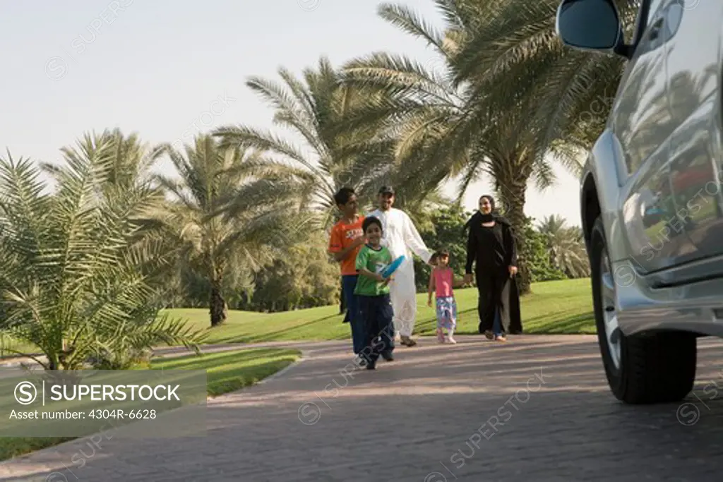 Father and mother with children at park