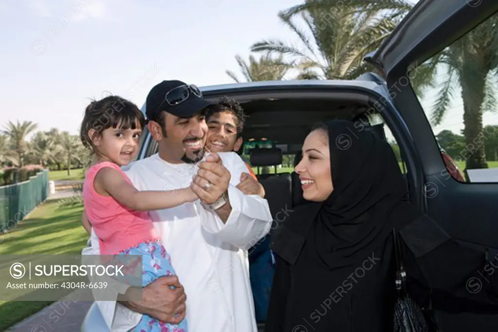Father and mother with children, smiling