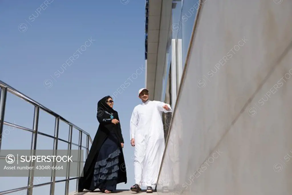 Young couple standing by railing