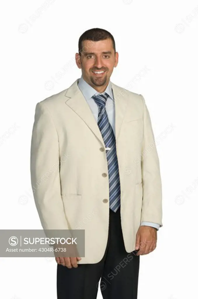 Businessman standing against white background, smiling, portrait