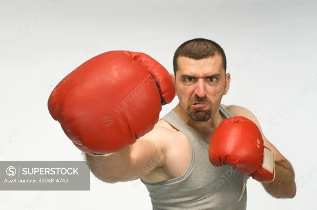 Mid adult man boxing, portrait