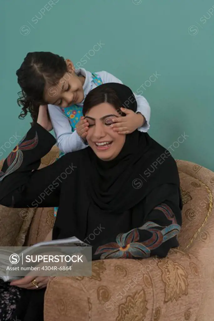 Daughter covering the eyes of her mother by hands