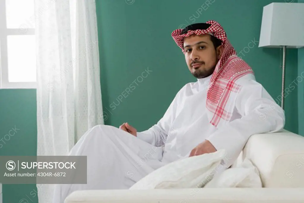 Arab man sitting on sofa