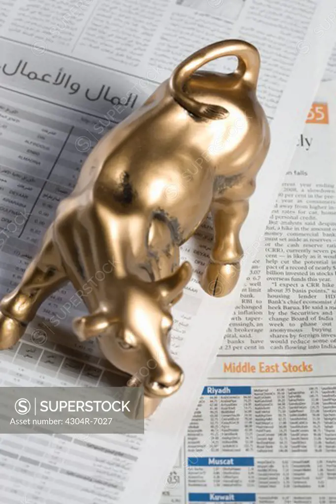 Bull figurine on newspaper, close-up