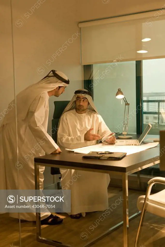 Two Arab businessmen discussing at work