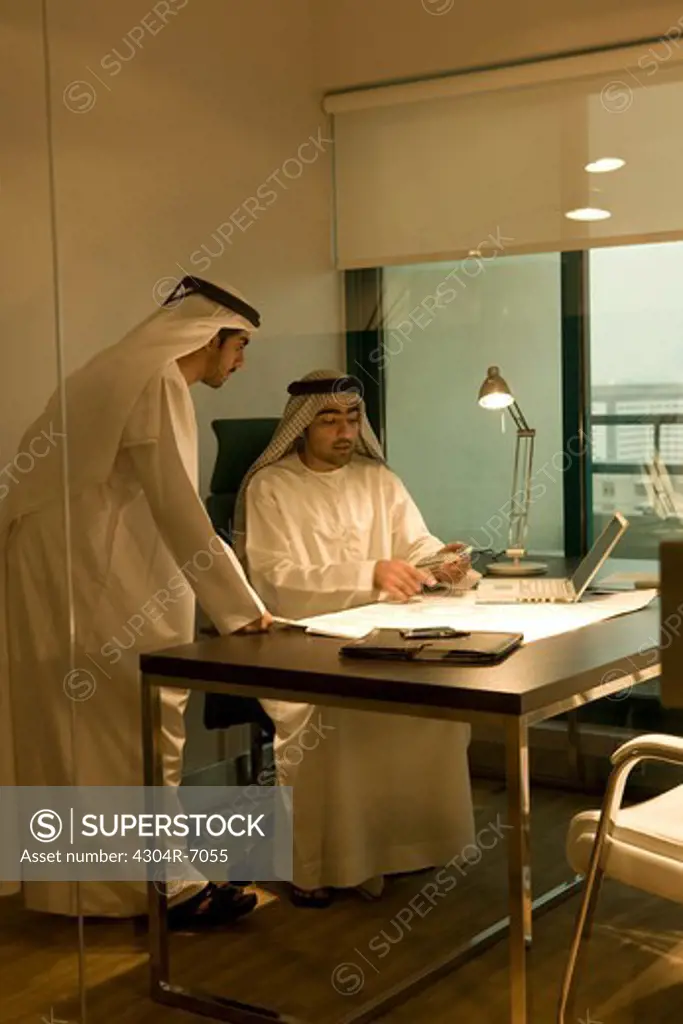 Two Arab businessman discussing at work
