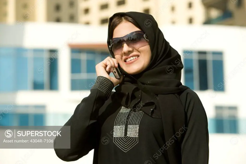 Arab businesswoman talking on Cellphone, standing