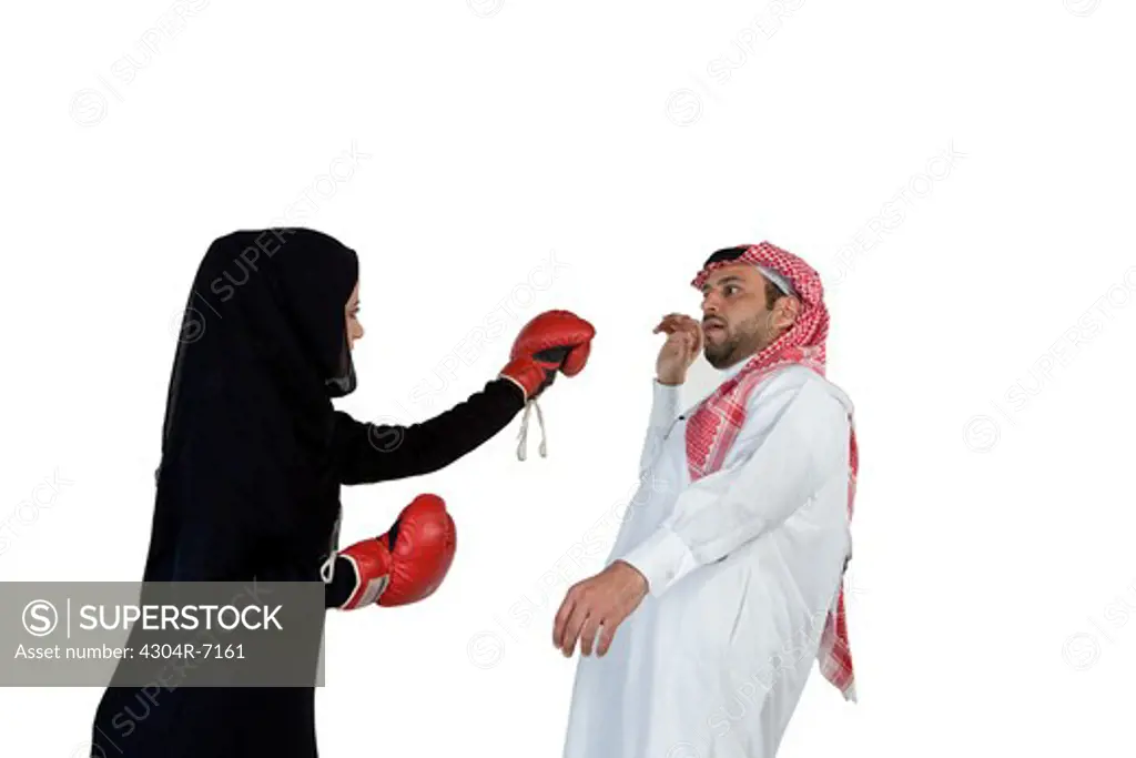 Arab woman with boxing gloves, punching arab man