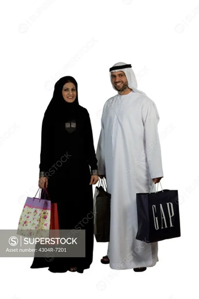 Arab couple with shopping bags, smiling