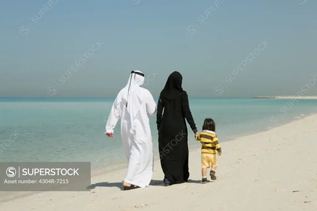 Arab family walking at the beach