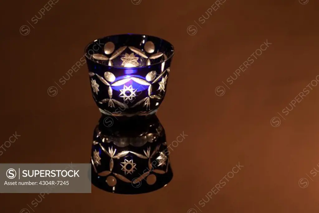 Illuminated one purple candle glass holder