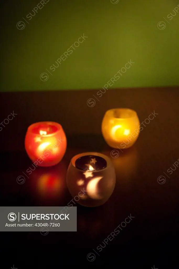 Illuminated three candle glass holder