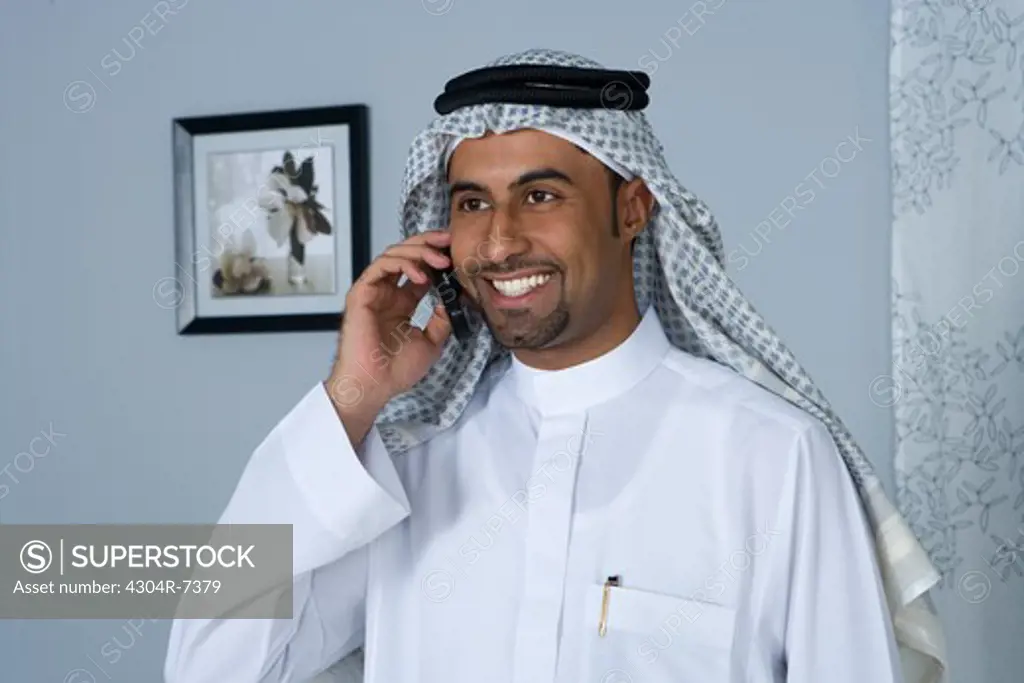 Arab man with cellphone, smiling