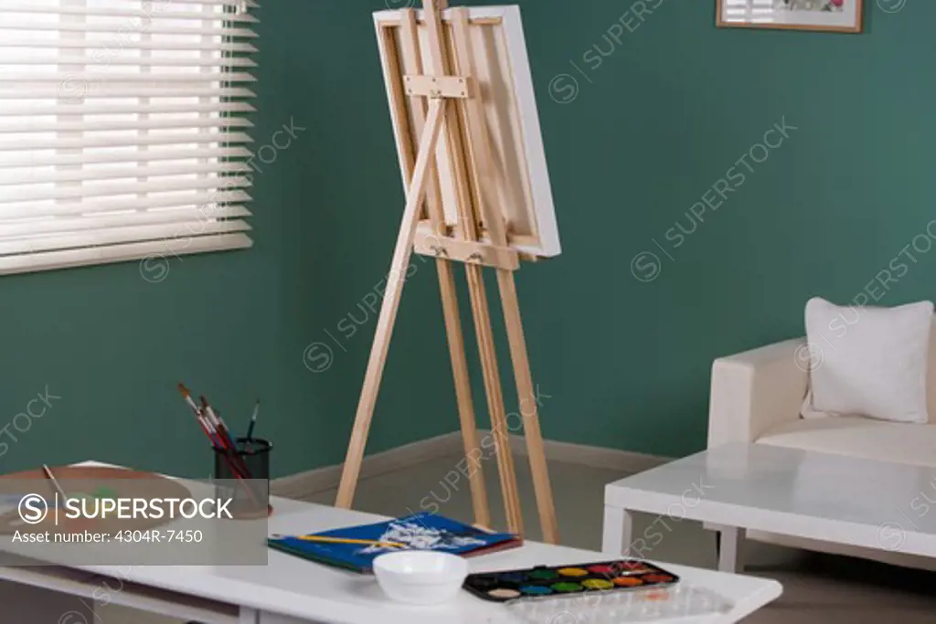 Easel with canvas and painting materials
