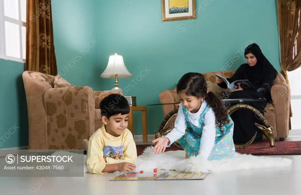 Arab mother with two children in the living room