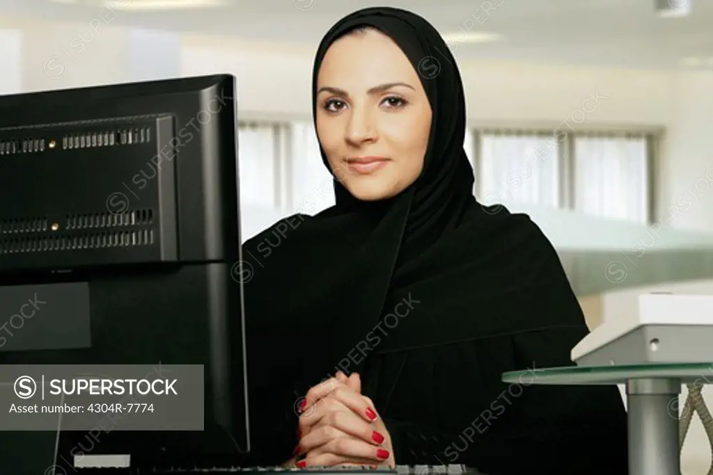 Arab lady busy on the computer.