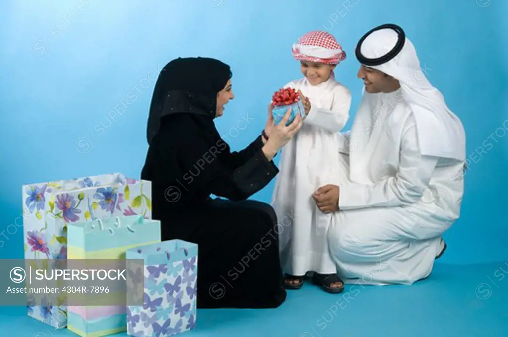 Arab family with shopping bags & gifts