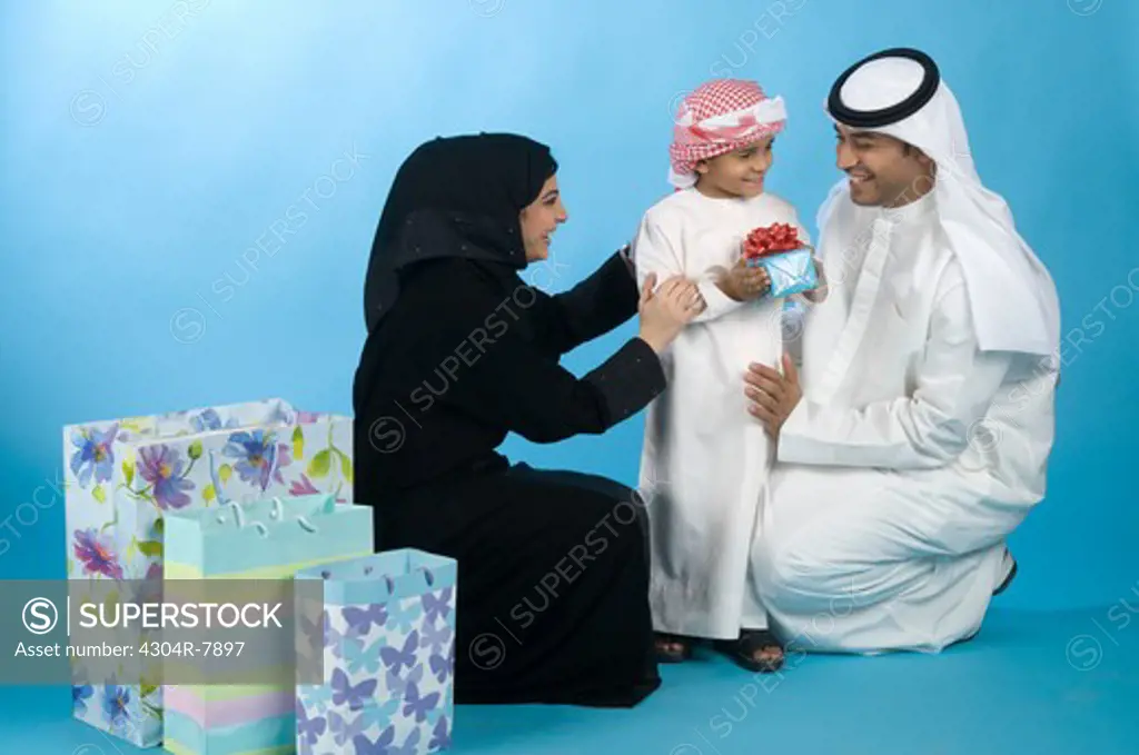Arab family with shopping bags & gifts