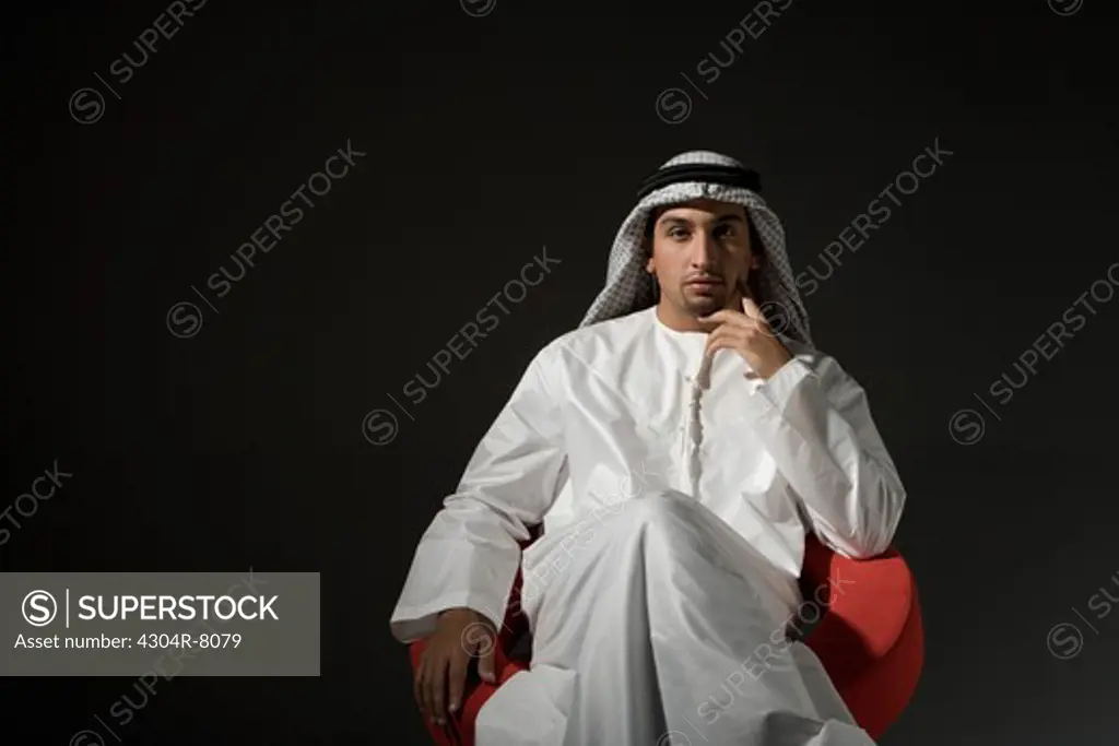 Young man sitting on chair, portrait